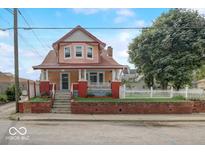 Charming two-story home featuring a welcoming front porch and well-maintained brick accents at 415 E 32Nd St, Indianapolis, IN 46205