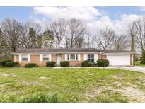 Charming single story brick home with attached garage and mature trees at 664 N County Road 800 E, Avon, IN 46123