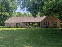 Charming single-story brick home featuring lush green lawn and mature trees at 8017 Dogwood Ct, Plainfield, IN 46168