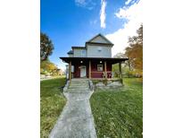 Charming two-story home with a welcoming front porch and well-maintained lawn, perfect for enjoying outdoor living at 905 W 3Rd St, Anderson, IN 46016