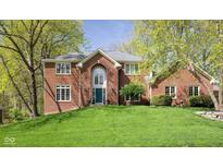 Charming brick home featuring a well-manicured lawn and lush trees, enhancing its curb appeal at 9838 Gulfstream Ct, Fishers, IN 46037