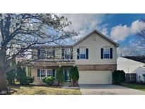 Traditional two-story home featuring green shutters, brick accents, and a well-maintained lawn at 10689 Brooks St, Indianapolis, IN 46234