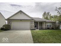 Charming single-story home with a well-manicured lawn and attached two-car garage at 12249 E Harvest Glen Dr, Cumberland, IN 46229