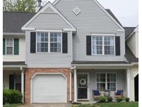 Charming townhome featuring a one-car garage, a cozy front porch, and professionally maintained landscaping at 12678 Brewton St, Fishers, IN 46038