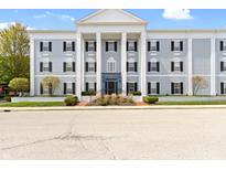Elegant building with stately columns and manicured landscaping offers a refined living experience at 12820 University Cres # 3D, Carmel, IN 46032