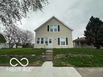 Charming two-story home with a well-manicured front yard, set back from the street at 137 S 2Nd Ave, Beech Grove, IN 46107