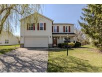 Charming two-story home featuring red shutters, a two-car garage, and well-maintained landscaping at 14117 Princewood Dr, Fishers, IN 46037
