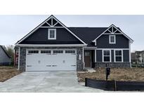 Charming home with a two-car garage, stone accents, and a modern design at 5125 Gerhing Dr, Indianapolis, IN 46239