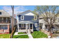 Charming two-story home featuring a welcoming front porch and freshly landscaped yard at 2326 Guilford Ave, Indianapolis, IN 46205