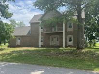 Traditional brick home with a balcony and a well-manicured lawn at 2365 E 850 N, Lebanon, IN 46052