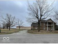 Traditional two-story home featuring a covered porch, dormer windows, and an expansive front yard at 2365 E 850 N, Lebanon, IN 46052