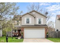 Charming two-story home featuring a two-car garage, brick accents, and mature trees in a well-kept front yard at 4417 Barharbor Ct, Indianapolis, IN 46268