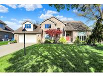 Two-story brick home featuring an attached two-car garage and well-manicured lawn at 4606 Sundance Trl, Indianapolis, IN 46239