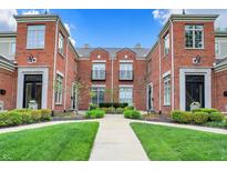 Brick townhome complex with manicured landscaping and a well-maintained walkway at 6430 Meridian Pkwy # Apt A, Indianapolis, IN 46220