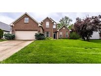 Beautiful two-story brick home featuring an attached garage and a lush green front lawn at 7131 Topp Creek Ct, Indianapolis, IN 46214