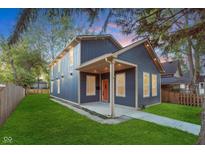 Charming two-story home with a manicured lawn and inviting front porch at 838 N Tacoma Ave, Indianapolis, IN 46201