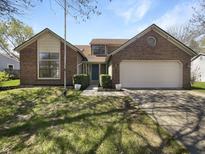 Charming two-story brick home with a well-maintained front yard and attached two car garage at 9162 Hadway Dr, Indianapolis, IN 46256