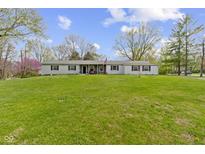 Charming ranch home with a well manicured lawn and classic architectural features at 10421 Hillsdale Dr, Carmel, IN 46032