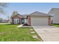 Charming single Gathering home with a two-car garage, red brick accents, and well-maintained landscaping at 2075 Sea Hero Ct, Indianapolis, IN 46234