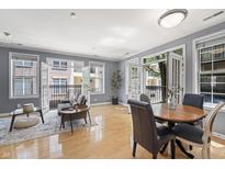 Open-concept living area with hardwood floors and french doors leading to balconies at 226 N Cleveland St # 226C, Indianapolis, IN 46204