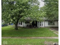 Traditional single-story home with a shaded front yard and a cozy front porch at 2508 N Routiers Ave, Indianapolis, IN 46219