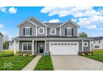 Beautiful two-story home featuring gray siding, a two-car garage, and a well-manicured lawn at 2712 Glade Ave, Plainfield, IN 46168