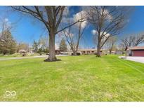 Expansive front yard with mature trees and lush lawn at 3303 Busy Bee Ln, Indianapolis, IN 46227