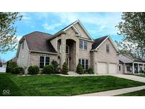 Charming two-story home with a well-manicured lawn and a stone-accented entrance at 3389 Grant Ct, Columbus, IN 47203