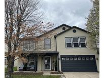 Charming two-story home with well-maintained lawn and front porch seating area at 5236 Skipping Stone Dr, Indianapolis, IN 46237