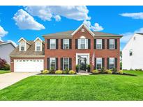 Traditional brick two-story home with well-maintained lawn and manicured landscaping at 5595 Auburndale Dr, Bargersville, IN 46106