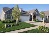 Charming single-story home with a manicured lawn, stone accents, and a two-car garage at 6341 Colonial Dr, Whitestown, IN 46075