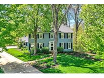 Charming two-story home with a lush green lawn and mature trees at 70 Williamsburg Ct, Zionsville, IN 46077
