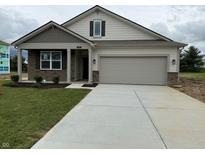 Charming single-story home with a two-car garage, stone accents, and a well-manicured front yard at 7533 Big Bend Blvd, Camby, IN 46113