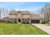 Charming two-story home with a well-manicured lawn and a two-car garage at 950 Nevelle Ln, Carmel, IN 46032