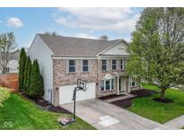 Beautiful two-story brick home featuring a two-car garage, basketball hoop, and a well-maintained front yard at 10362 Delphi Ct, Fishers, IN 46038