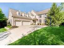 Spacious two-story home features a three-car garage, dormer windows, and mature landscaping at 10752 Tallow Wood Ln, Indianapolis, IN 46236