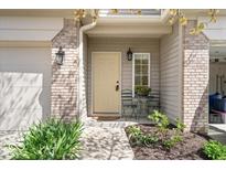 Charming front porch features a cozy seating area, decorative lighting, and well maintained landscaping at 11264 Fonthill Dr, Indianapolis, IN 46236