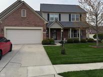Charming two-story home featuring a well-manicured lawn and a combination of brick and vinyl siding at 11786 Ledgestone Cir, Fishers, IN 46037