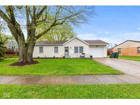 Charming single-story home featuring a well-maintained lawn and mature tree, enhancing curb appeal at 1213 Fairview Dr, Greenfield, IN 46140