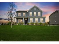 Charming two-story home with well-manicured lawn and inviting front porch at 12902 Girvan Way, Fishers, IN 46037