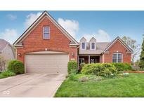 Charming brick home with a manicured lawn, mature landscaping, and a welcoming two-car garage at 1361 Trescott Dr, Westfield, IN 46074