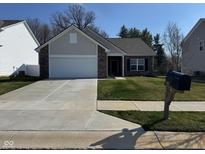 Charming single-story home with a well-manicured front yard and a two car garage at 142 Winding Brook Way, Pendleton, IN 46064