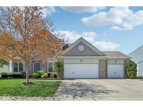 Charming two-story home with three-car garage and well-maintained front yard at 14323 Chariots Whisper Dr, Carmel, IN 46074