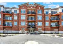 Stunning exterior of a brick condominium building with balconies and well-maintained landscaping at 20971 Shoreline Ct # 306, Noblesville, IN 46062
