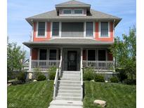 Charming two-story home with a welcoming front porch and landscaped front yard at 302 Sanders St, Indianapolis, IN 46225