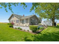 Charming home featuring a welcoming deck and lush landscaping at 403 N Red Gold Dr, Trafalgar, IN 46181
