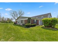Charming home featuring a well-maintained lawn and lush landscaping on a sunny day at 4464 Four Seasons Cir, Indianapolis, IN 46226