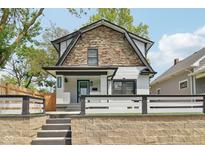 Charming two-story home features a stone accent wall, a freshly painted exterior, and a well-manicured front yard at 625 N Temple Ave, Indianapolis, IN 46201