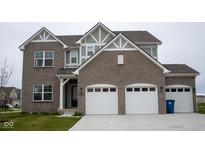 Charming two-story home featuring a brick facade, attached two-car garage, and well-maintained front lawn at 6304 Frst Brk Dr, Indianapolis, IN 46259