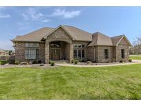 Charming single-story brick home with manicured lawn, mature landscaping, and covered front entryway at 6472 Independence Ct, Pendleton, IN 46064